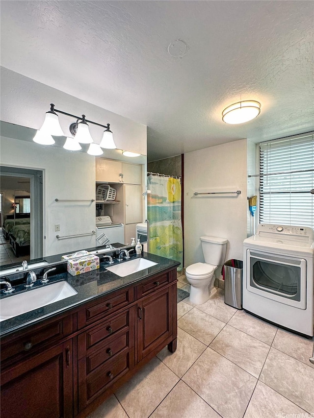 84-664 Ala Mahiku St Unit 196A, Waianae, HI 96792 - bathroom featuring washer / clothes dryer, toilet, a textured ceiling, double vanity, and tile patterned floors