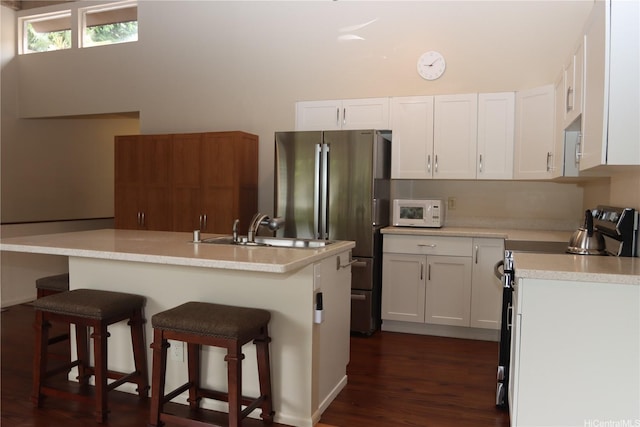 47-665 Hui Kelu St Unit 7702, Kaneohe, HI 96744 - kitchen featuring stainless steel appliances, light countertops, white cabinets, and a kitchen bar