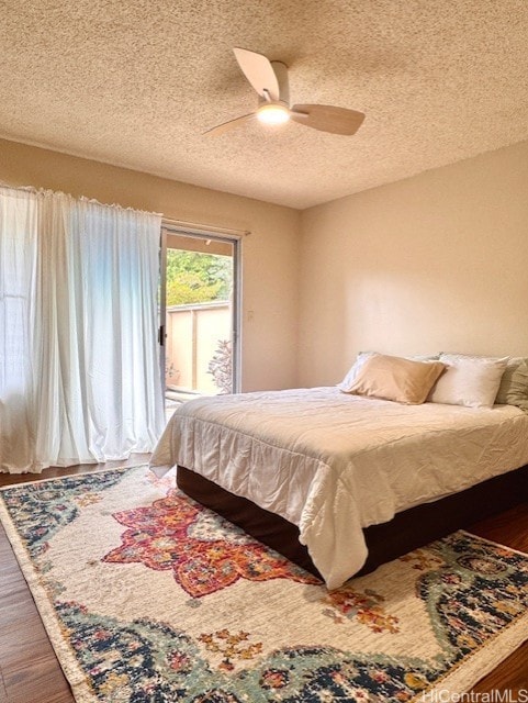 47-665 Hui Kelu St Unit 7702, Kaneohe, HI 96744 - bedroom featuring access to outside, wood finished floors, a textured ceiling, and a ceiling fan