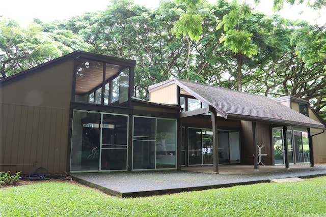 47-665 Hui Kelu St Unit 7702, Kaneohe, HI 96744 - back of house featuring a patio, a sunroom, a yard, and roof with shingles