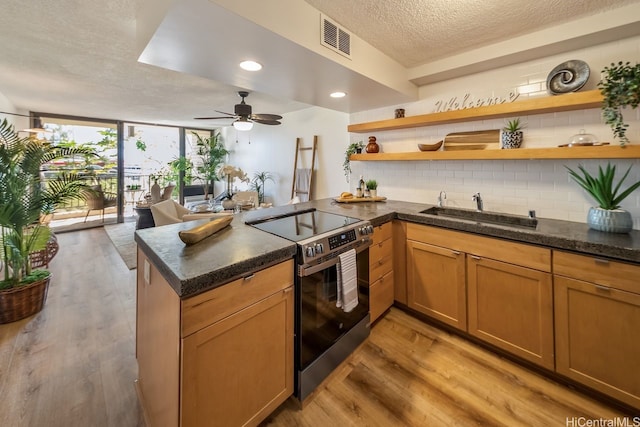 3138 Waialae Ave Unit 230, Honolulu, HI 96816 - kitchen with stainless steel electric stove, a sink, a peninsula, open shelves, and a textured ceiling