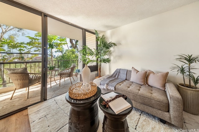 3138 Waialae Ave Unit 230, Honolulu, HI 96816 - living room featuring expansive windows, a textured ceiling, and wood finished floors