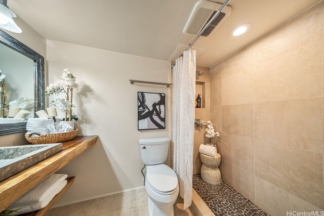 3138 Waialae Ave Unit 230, Honolulu, HI 96816 - full bath featuring tiled shower, toilet, tile patterned flooring, and baseboards