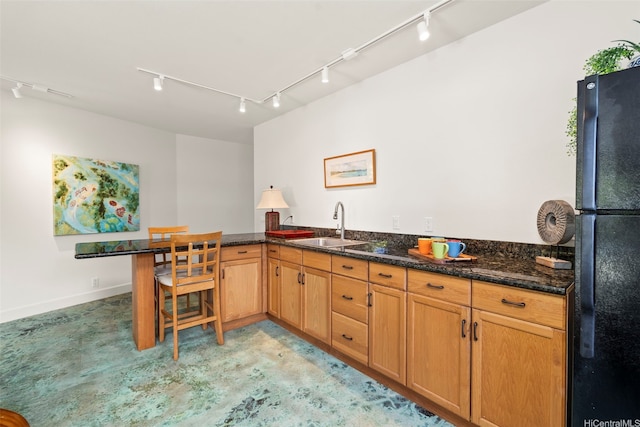 176 Kaiholu St, Kailua, HI 96734 - kitchen featuring freestanding refrigerator, track lighting, a sink, a peninsula, and dark stone countertops