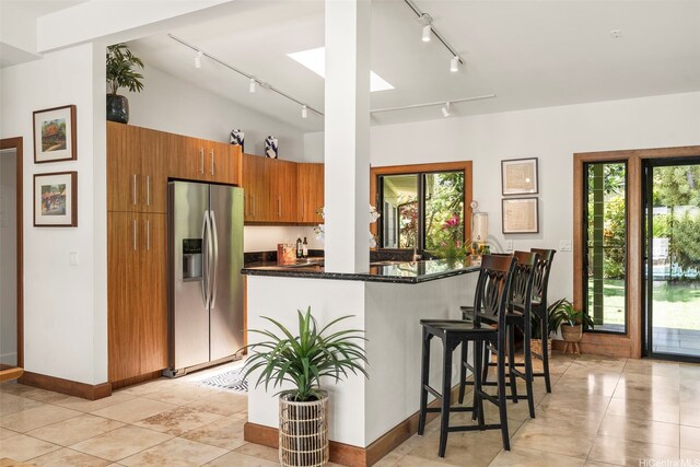 176 Kaiholu St, Kailua, HI 96734 - kitchen featuring stainless steel fridge, track lighting, brown cabinets, healthy amount of natural light, and lofted ceiling
