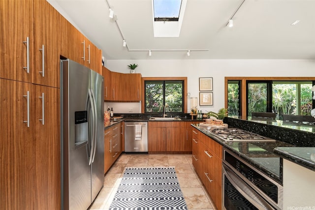 176 Kaiholu St, Kailua, HI 96734 - kitchen with stainless steel appliances, rail lighting, brown cabinets, and a sink
