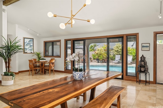 176 Kaiholu St, Kailua, HI 96734 - dining area featuring track lighting, vaulted ceiling, a chandelier, light tile patterned floors, and baseboards