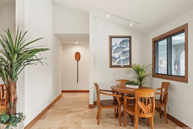 176 Kaiholu St, Kailua, HI 96734 - dining space featuring rail lighting, vaulted ceiling, and baseboards