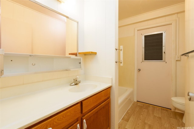 1157 Ala Aloalo St, Honolulu, HI 96818 - bathroom featuring wood finished floors, toilet, vanity, and a bath