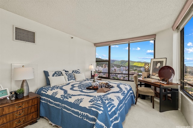 1221 Victoria St Unit 3205, Honolulu, HI 96814 - carpeted bedroom with multiple windows, a textured ceiling, a mountain view, expansive windows, and an office area