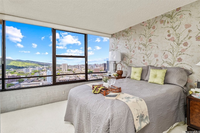 1221 Victoria St Unit 3205, Honolulu, HI 96814 - bedroom featuring a city view, carpet, wallpapered walls, multiple windows, and a textured ceiling