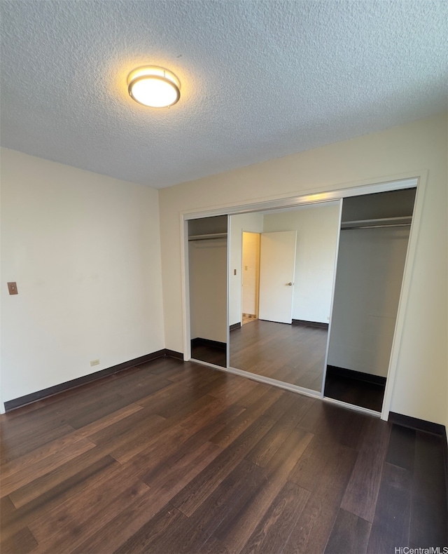 1323 Makiki St Unit A304, Honolulu, HI 96814 - unfurnished bedroom with dark wood finished floors, a textured ceiling, and a closet