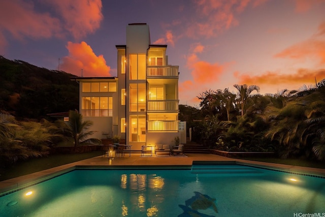 7421 Mokuhano Pl, Honolulu, HI 96825 - pool at dusk featuring a patio area, an outdoor pool, and stairway