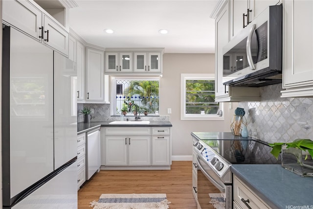 7421 Mokuhano Pl, Honolulu, HI 96825 - kitchen featuring appliances with stainless steel finishes, backsplash, plenty of natural light, white cabinets, and recessed lighting