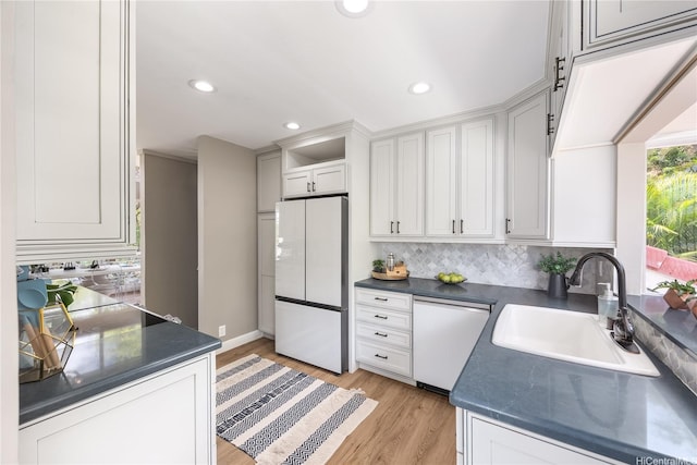 7421 Mokuhano Pl, Honolulu, HI 96825 - kitchen with freestanding refrigerator, dishwasher, dark countertops, tasteful backsplash, and recessed lighting