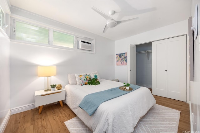 7421 Mokuhano Pl, Honolulu, HI 96825 - bedroom with wood finished floors, an AC wall unit, a closet, and ceiling fan