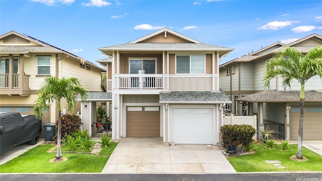 91-1200 Keaunui Dr Unit 204, Ewa Beach, HI 96706 - view of front of house with a shingled roof, concrete driveway, a balcony, an attached garage, and board and batten siding