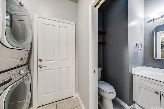 91-1200 Keaunui Dr Unit 204, Ewa Beach, HI 96706 - laundry room with stacked washer / dryer and light wood-style flooring