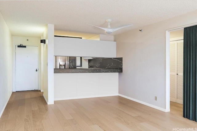 990 Ala Nanala St Unit 27D, Honolulu, HI 96818 - kitchen featuring wood finished floors, stainless steel refrigerator with ice dispenser, ceiling fan, baseboards, and a textured ceiling