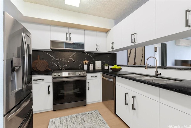 990 Ala Nanala St Unit 27D, Honolulu, HI 96818 - kitchen with appliances with stainless steel finishes, a sink, tasteful backsplash, white cabinets, and dark countertops