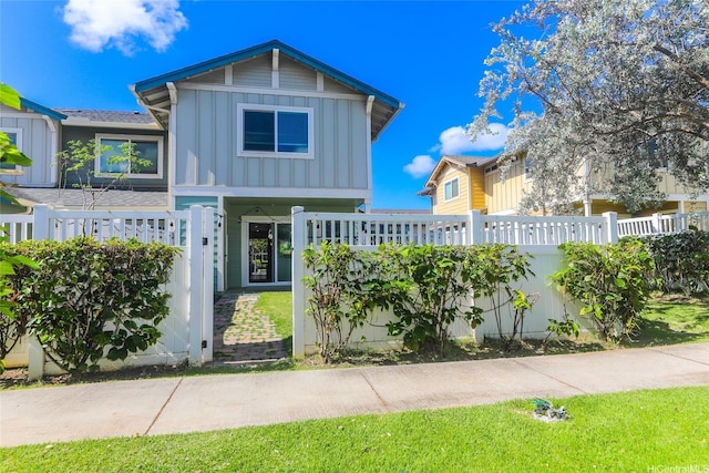 724 Kakala St Unit 1801, Ewa Beach, HI 96706 - view of front of property with board and batten siding and a fenced front yard