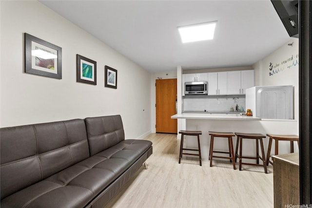 1088 Bishop St Unit 1008, Honolulu, HI 96813 - living room featuring light wood-type flooring and baseboards