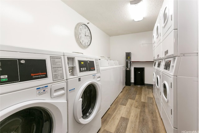 1088 Bishop St Unit 1008, Honolulu, HI 96813 - community laundry featuring stacked washer and clothes dryer, independent washer and dryer, light wood-type flooring, and a textured ceiling