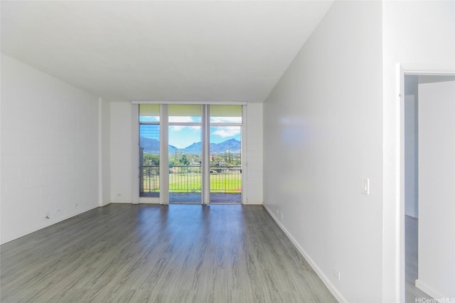 1830 Wilikina Dr Unit 1006, Wahiawa, HI 96786 - unfurnished living room with a mountain view, wood finished floors, floor to ceiling windows, and baseboards
