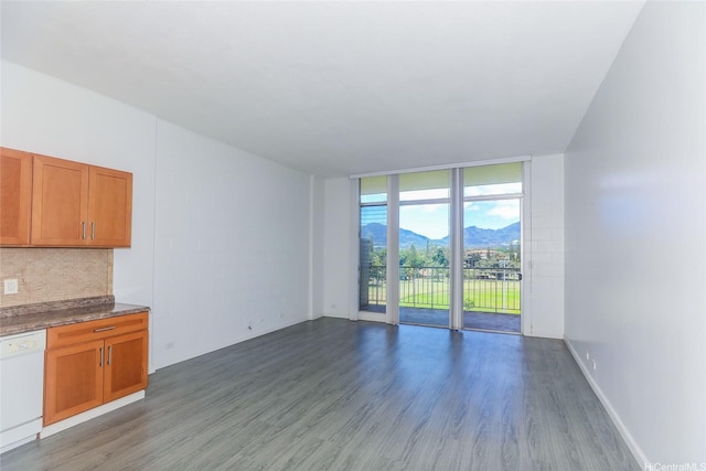 1830 Wilikina Dr Unit 1006, Wahiawa, HI 96786 - unfurnished living room with wood finished floors, a mountain view, and a wall of windows
