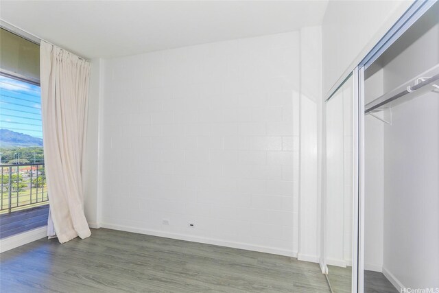 1830 Wilikina Dr Unit 1006, Wahiawa, HI 96786 - unfurnished bedroom featuring access to outside, wood finished floors, baseboards, and a closet