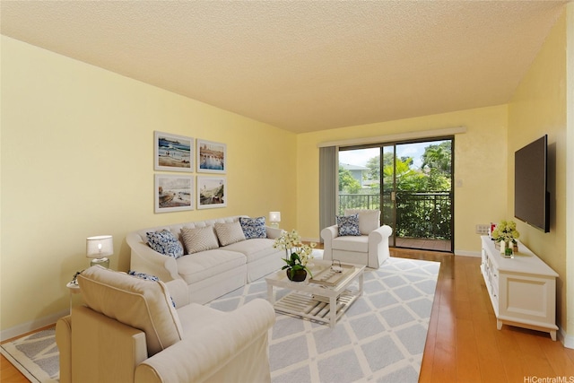 98-364 Kaonohi St Unit 11/386, Aiea, HI 96701 - living area featuring light wood-style floors and a textured ceiling