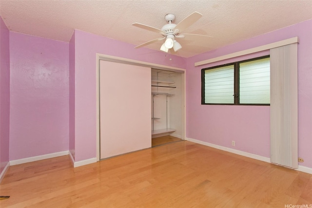 98-364 Kaonohi St Unit 11/386, Aiea, HI 96701 - unfurnished bedroom with wood finished floors, a closet, a textured ceiling, and ceiling fan