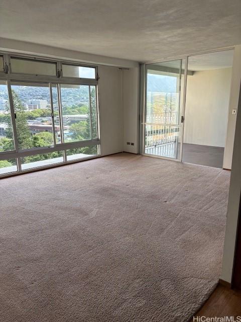 1519 Nuuanu Ave Unit 1042, Honolulu, HI 96817 - spare room with healthy amount of natural light and carpet floors