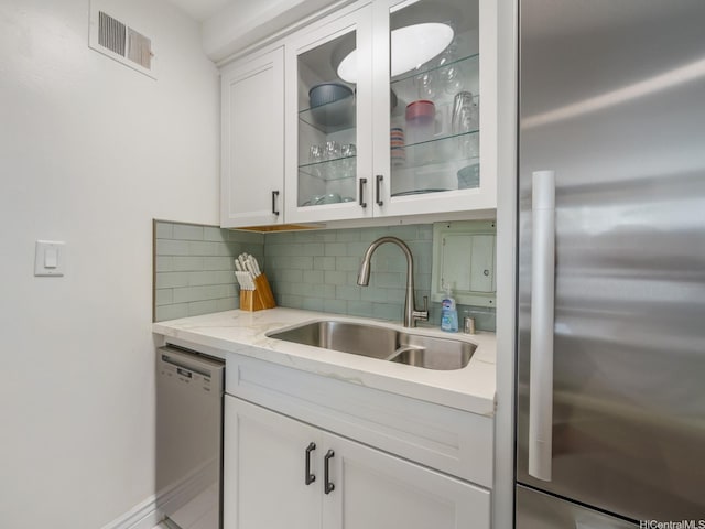 445 Kaiolu St Unit 409, Honolulu, HI 96815 - bar area with stainless steel fridge, dishwashing machine, a sink, and backsplash