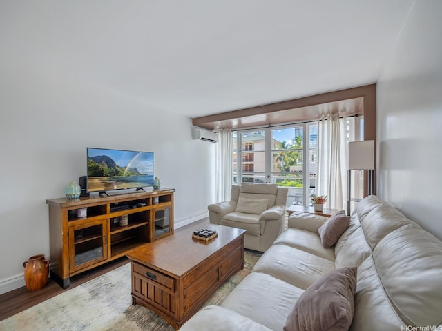 445 Kaiolu St Unit 409, Honolulu, HI 96815 - living area featuring an AC wall unit, baseboards, and wood finished floors