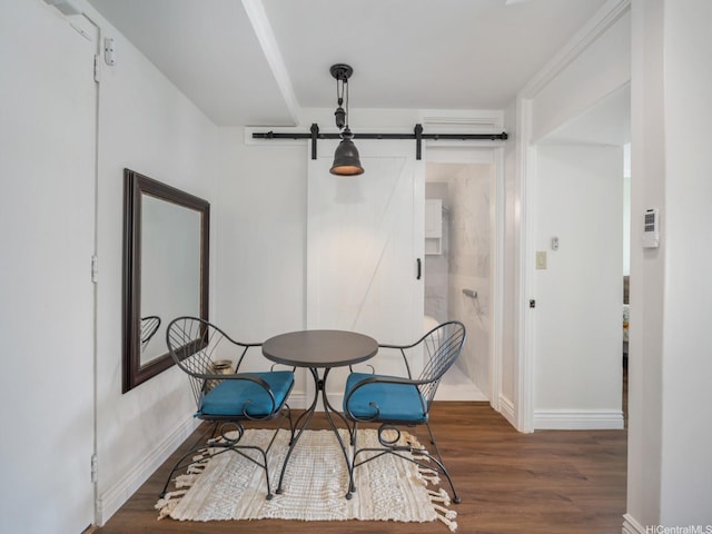 445 Kaiolu St Unit 409, Honolulu, HI 96815 - dining space featuring a barn door, wood finished floors, and baseboards