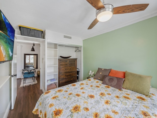 445 Kaiolu St Unit 409, Honolulu, HI 96815 - bedroom featuring wood finished floors, a ceiling fan, a closet, and crown molding
