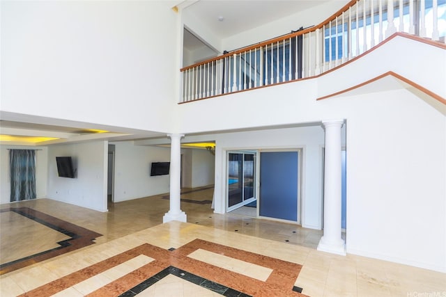 736 Ulili St, Honolulu, HI 96816 - unfurnished living room with ornate columns, inlaid floor details, a towering ceiling, and tile patterned floors