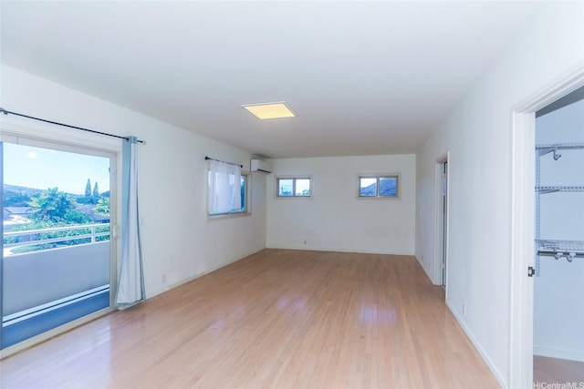 736 Ulili St, Honolulu, HI 96816 - empty room with light wood-type flooring and a wall mounted air conditioner