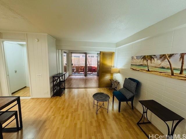 417 Nohonani St Unit 311, Honolulu, HI 96815 - sitting room with wood finished floors and a textured ceiling