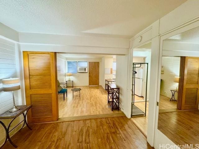 417 Nohonani St Unit 311, Honolulu, HI 96815 - hallway featuring wood finished floors, cooling unit, and a textured ceiling