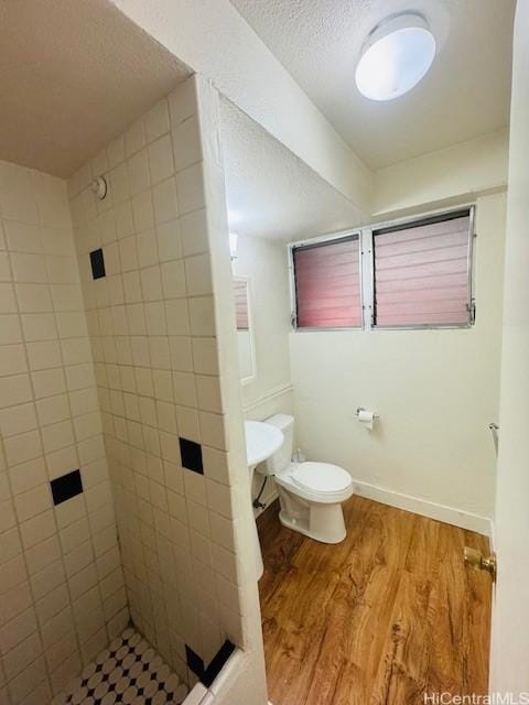 417 Nohonani St Unit 311, Honolulu, HI 96815 - full bathroom with a shower stall, wood finished floors, and a textured ceiling