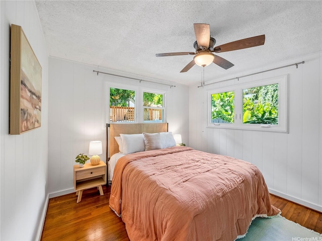 45-141A Kokokahi Pl, Kaneohe, HI 96744 - bedroom with hardwood / wood-style floors, a textured ceiling, ceiling fan, and baseboards