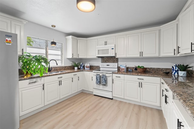 7528 Olili Pl, Honolulu, HI 96825 - kitchen with white appliances, light wood-style flooring, white cabinetry, and hanging light fixtures