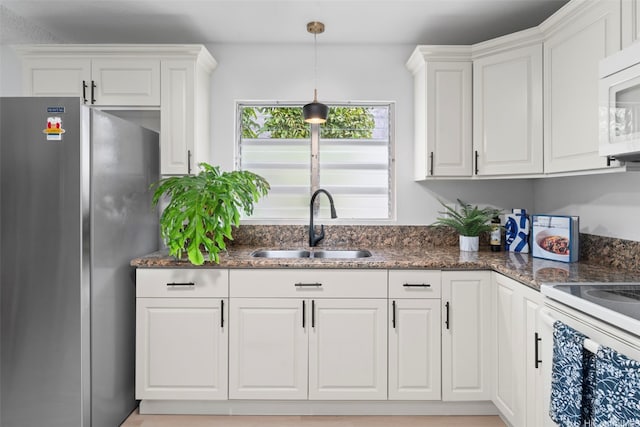 7528 Olili Pl, Honolulu, HI 96825 - kitchen featuring white appliances, white cabinetry, and hanging light fixtures