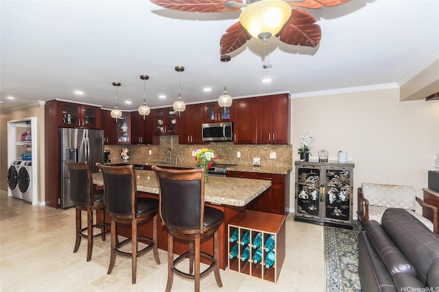 477 Opihikao Place -, Honolulu, HI 96825 - kitchen featuring stainless steel appliances, separate washer and dryer, decorative backsplash, a kitchen bar, and crown molding