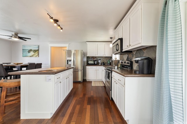 54-298 Hauula Homestead Rd Unit A, Hauula, HI 96717 - kitchen with stainless steel appliances, dark countertops, a ceiling fan, and dark wood-style floors