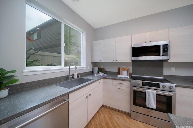 91-1160 Kamakana St Unit 608, Ewa Beach, HI 96706 - kitchen with appliances with stainless steel finishes, dark countertops, and light wood-type flooring