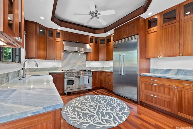47 Kaapuni Dr, Kailua, HI 96734 - kitchen with high quality appliances, under cabinet range hood, ceiling fan, brown cabinetry, and a sink