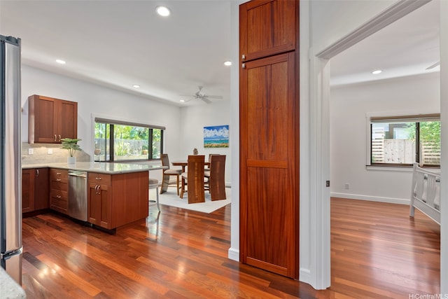 47 Kaapuni Dr, Kailua, HI 96734 - kitchen with a peninsula, stainless steel appliances, dark wood-type flooring, recessed lighting, and a breakfast bar area